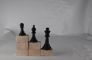 Chess pieces' from wooden cubes show the concepts of equity. Business concept photo