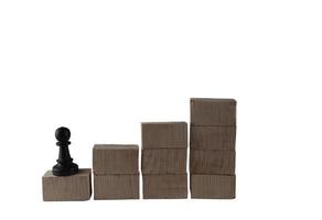 chess pieces on a wooden block. concept of goals of an employee who wants to achieve the highest success photo