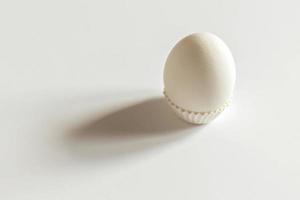 White egg on a white isolated background with shadow. Ingredient.Healthy food.Easter. photo