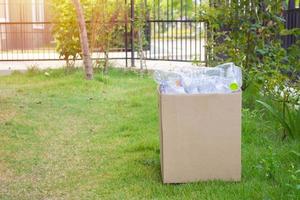 plastic bottles in brown recycle garbage box photo