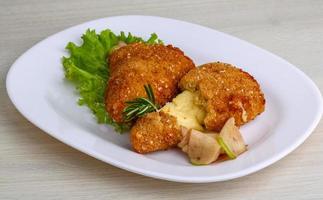 Fried cheese on the plate and wooden background photo