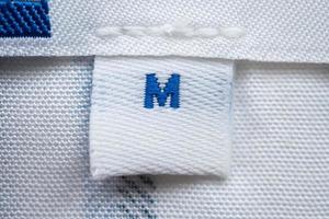 White clothes label close up on new shirt photo