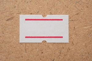 White paper sticker price on wooden background photo