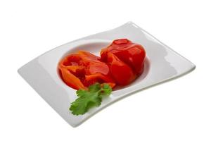 Marinated pepper in a bowl on white background photo