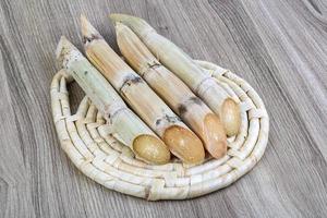 Sugar sticks on wooden board and wooden background photo