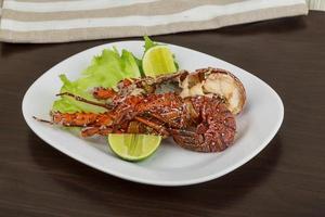 Spiny lobster on the plate and wooden background