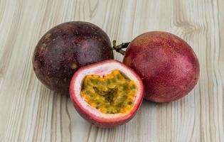 Passion fruit on wooden background photo