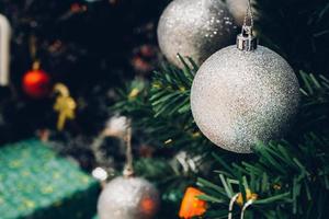 Decorated Christmas tree with colorful bauble on sparkling bokeh light blurred background photo