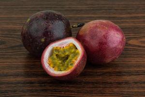 Passion fruit on wooden background photo