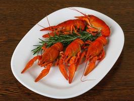 Crayfish on the plate and wooden background photo