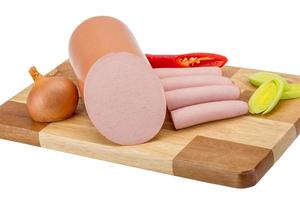 Sausages on wooden board and white background photo