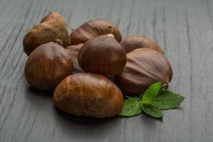 Chestnut on wooden background photo