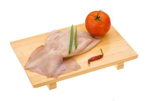 Raw squid on wooden board and white background photo