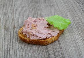Pate sandwich on wooden background photo