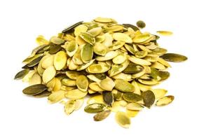 Pumpkin seeds on white background photo