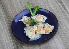 Shrimp wanton on the plate and wooden background photo