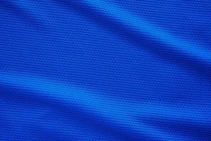 Blue football jersey clothing fabric texture sports wear background, close up top view photo