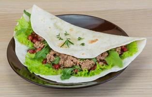 Burrito on the plate and wooden background photo