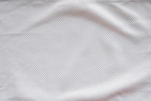 White fabric sport clothing football jersey with air mesh texture background photo