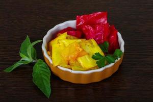 Pickled cabbage in a bowl on wooden background photo