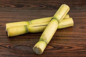 Sugar reed on wooden background photo