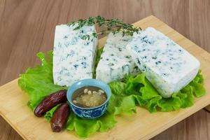 Blue cheese on wooden board and wooden background photo