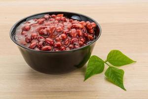 Red beans in a bowl on wooden background photo