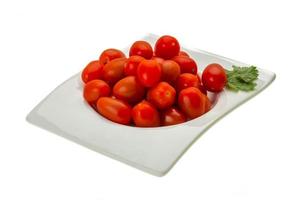 Cherry tomatoes in a bowl on white background photo