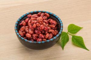 Red beans in a bowl on wooden background photo