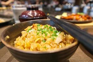 stir fried garlic rice with chopsticks close up photo