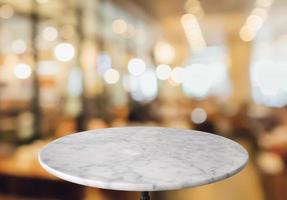 round marble table top with cafe restaurant bokeh lights abstract background for montage product display photo