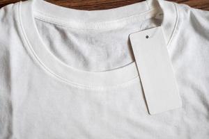 Blank price tag label on white t-shirt photo