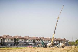 House building at construction site with crane truck photo