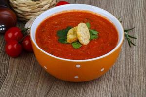 Gazpacho in a bowl on wooden background photo