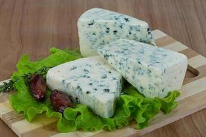 Blue cheese on wooden board and wooden background photo