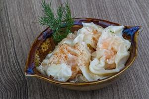 Shrimp wanton in a bowl on wooden background photo