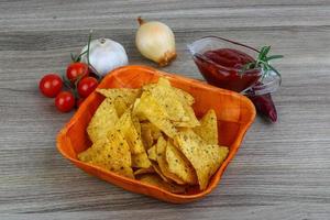 Nachos in a bowl on wooden background photo