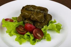 Dolma on the plate and wooden background photo