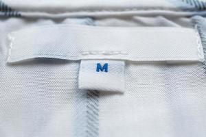 White clothes label close up on new shirt photo