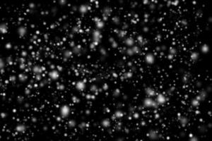 Abstract snowfall on black background photo