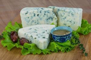 Blue cheese on wooden board and wooden background photo