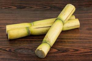 Sugar reed on wooden background photo