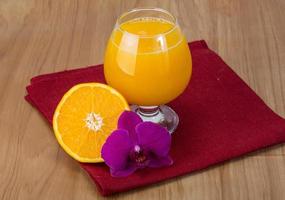 Orange juice on wooden background photo