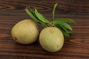 Sapodilla on wooden background photo