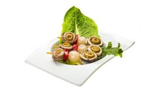 Anchovy rolls in a bowl on white background photo