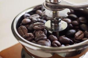 Vintage manual coffee grinder with roasted coffee beans photo