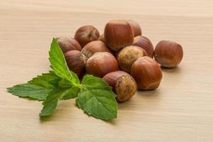 Hazelnut heap on wooden background photo