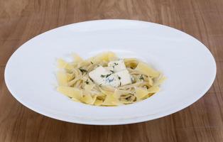 Cheese pasta on the plate and wooden background photo