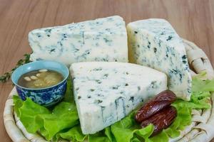 Blue cheese on wooden board and wooden background photo