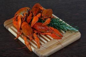 Crayfish on wooden board and wooden background photo